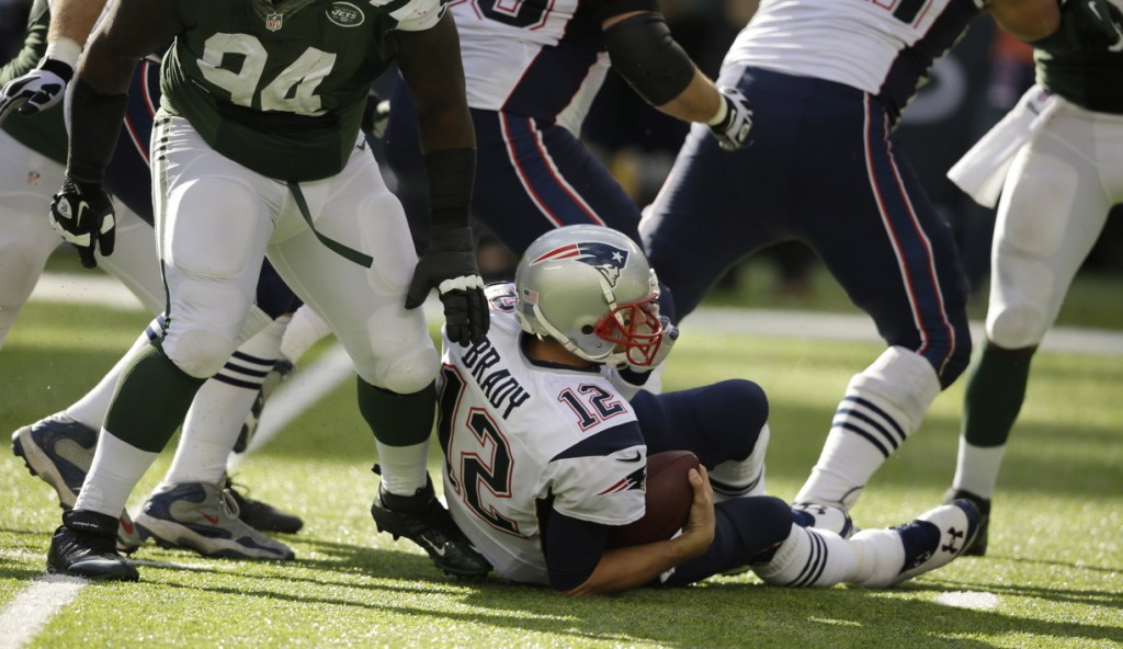 Tom Brady is sacked by the Jets’ Damon Harrison (94) during the second half of New York’s overtime win – one of four times the Jets put the New England quarterback on the ground.