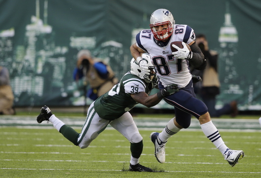 Rob Gronkowski tries to pull away from Antonio Allen after catching a first-down pass during the Patriots’ only possession in overtime. After the drive fizzled, the Patriots punted and the Jets – aided by a penalty – kicked the winning field goal.