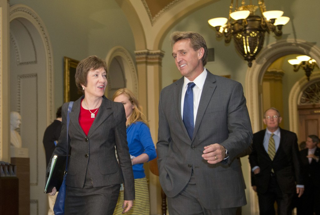 Sen. Jeff Flake, R-Ariz., right, and Sen. Susan Collins, R-Maine., walk together on Capitol Hill on Wednesday in Washington. Leaders reached a last-minute agreement to avert a threatened Treasury default and reopen the government after a partial, 16-day shutdown.