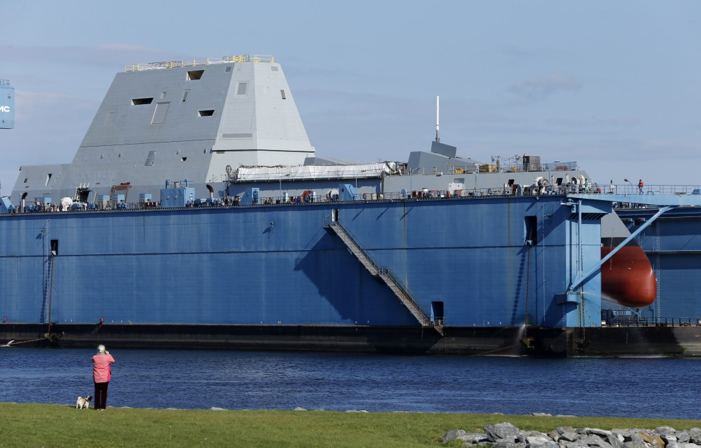 The first-in-class Zumwalt, the largest U.S. Navy destroyer ever built, is seen in dry dock Monday in Bath. The ship features an unusual wave-piercing hull, electric drive propulsion, advanced sonar and guided missiles, and a new gun that fires rocket-propelled warheads as far as 100 miles.