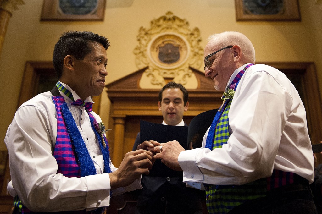 David Gibson, right, and Richard Kiamco of Jersey City make history as they become the first official same-sex couple to be married in Jersey City in a ceremony officiated by Mayor Steve Fulop at 12:01 a.m. Monday. Seven other gay couples also participated in the ceremony.