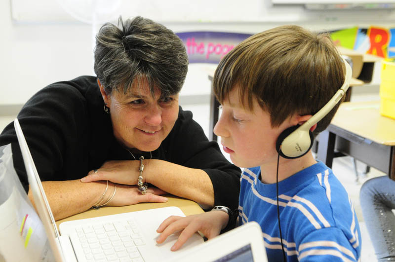 Principal Lori Smail chats with student Sam Goldey during a classroom visit Wednesday at Farrington School in Augusta.