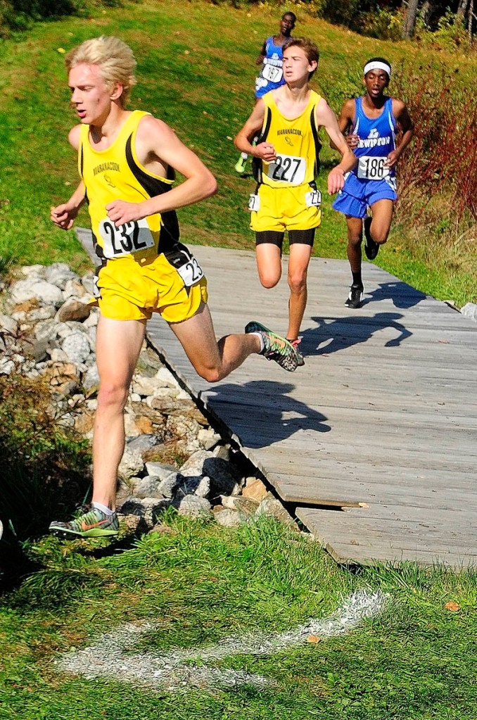 Maranacook's Jason Stevenson, (232), left, and Austin Landry (227) run over a bridge during the KVAC cross country championships on Saturday October 19, 2013 at Cony High School in Augusta.