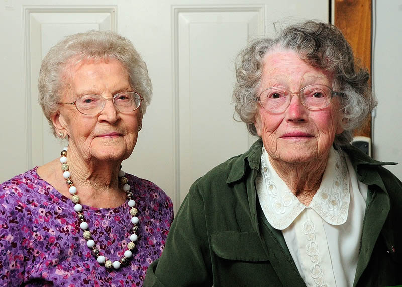 The oldest two members of the Belgrade High School class of 1933, Pearl Knowles Fisher and Ruth Endicott Freeman, pose for a photo on Thursday at Fisher's Augusta apartment.