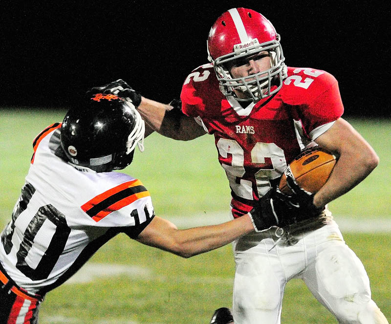 Gardiner defensive back Chase Begin, left, tries but can't bring down Cony wide receiver John Bennett during the Cony-Gardiner rivalry game Friday at Alumni Field in Augusta. Cony won 76-14.