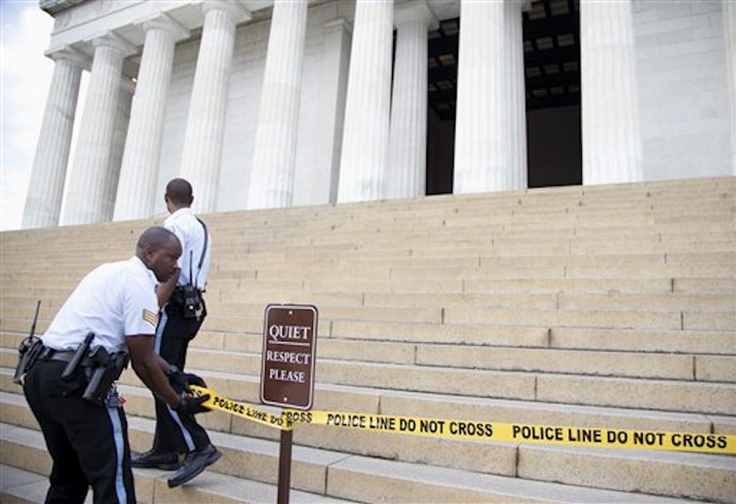 US Park Police officers pull police tape across the steps closing access to the Lincoln Memorial in Washington, Tuesday, Oct. 1, 2013. Congress plunged the nation into a partial government shutdown Tuesday as a long-running dispute over President Barack Obama’s health care law stalled a temporary funding bill, forcing about 800,000 federal workers off the job and suspending most non-essential federal programs and services.