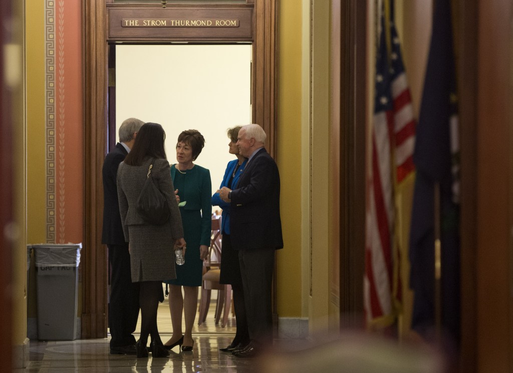 Sen. Susan Collins, R-Maine, center, talks with, from left, Sen. Rob Portman, R-Ohio, Sen.. Kelly Ayotte, R-N.H., Sen. Lisa Murkowski, R- Alaska, and Sen. John McCain, R- Ariz., on Capitol Hill in Washington, on Friday. Republicans are offering to pass legislation to avert a default and end the 11-day partial government shutdown as part of a framework that would include cuts in benefit programs, officials said Friday.
