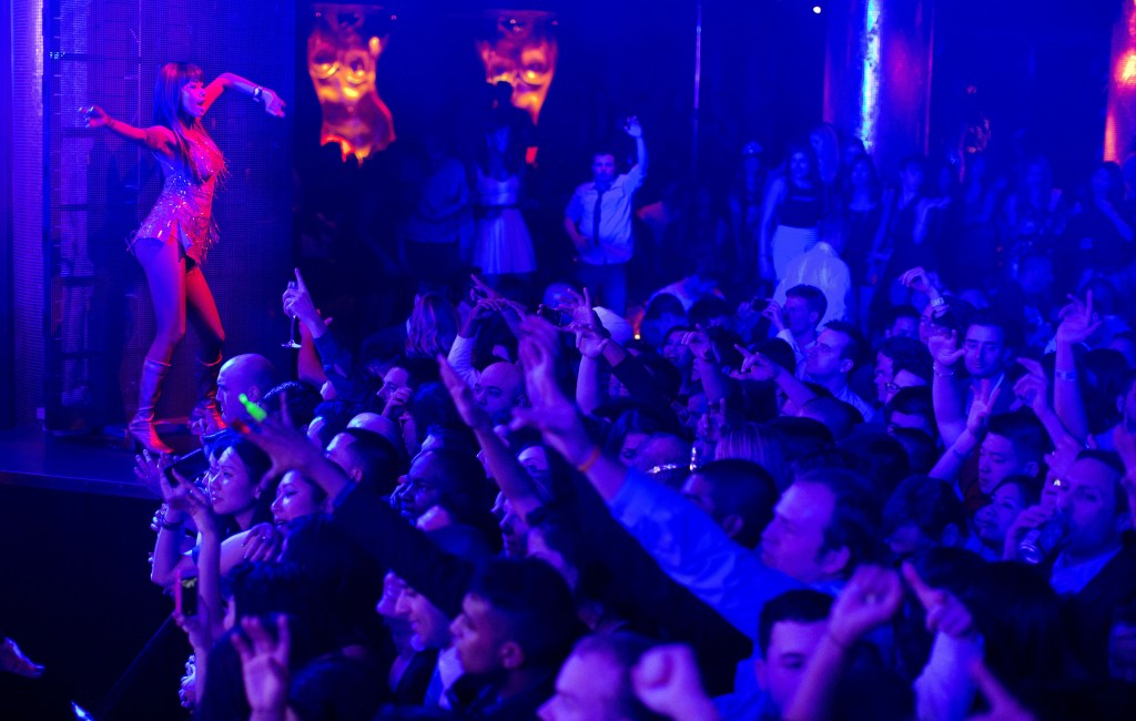 Revelers are led by professional dancers as DJ Afrojack plays his mixes at the XS nightclub in Las Vegas. A poll conducted this year by the national gambling lobby found that 26 percent of casino-goers now eschew wagering, and the city’s growing mega-clubs are threatening to become the most lucrative draw for a town built on betting.