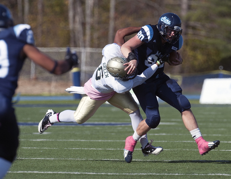 Maine receiver Justin Perillo (80) gets tackled by William and Mary linebacker Airek Green (6) after a reception in the first half of an NCAA college football game Saturday, Oct. 19, 2013, in Orono, Maine. (AP Photo/Michael C. York)