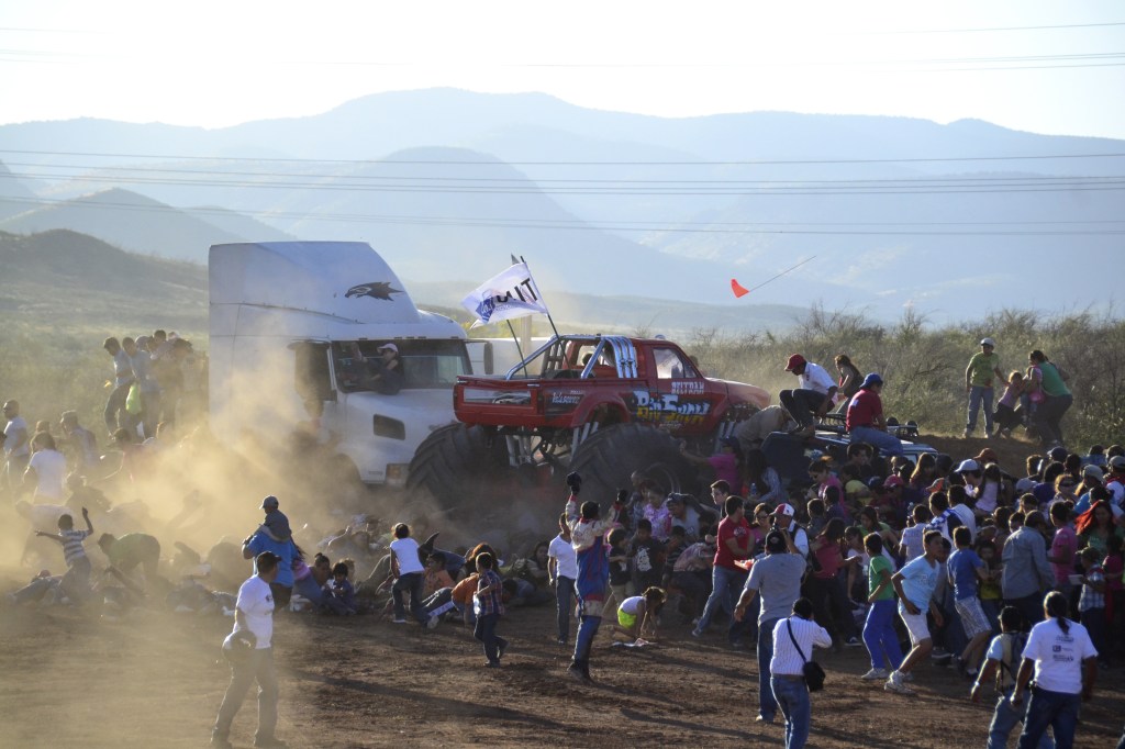 People run as an out of control monster truck plows through a crowd of spectators at a Mexican air show in the city of Chihuahua, Mexico, Saturday Oct. 5, 2013. According to authorities, at least 8 people were killed and 80 were injured.