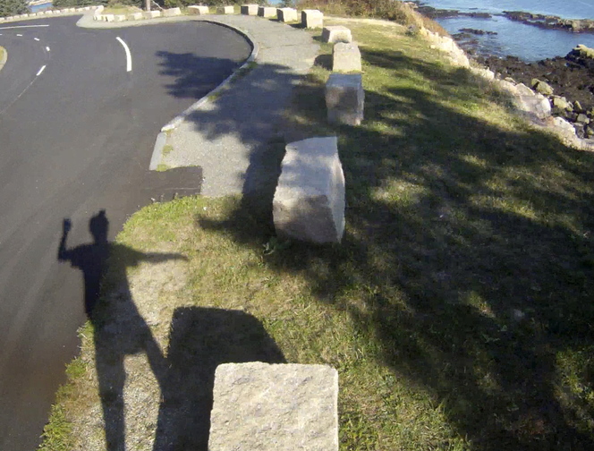 Glenn Jordan takes a break from pedaling the 27-mile Park Loop Road to do a bit of rock hopping on large granite barrier stones that line the road.