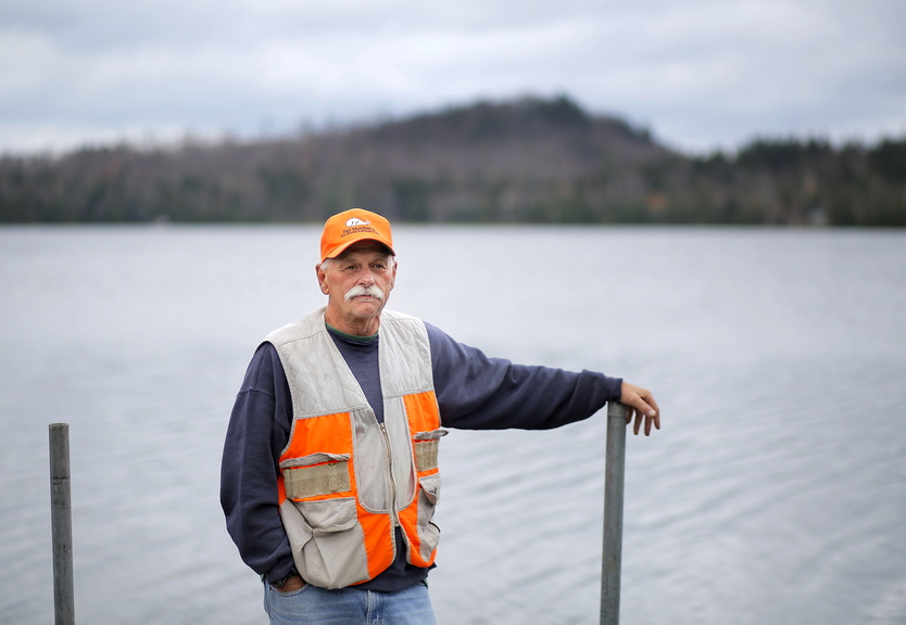 Rodney Jones of Fort Fairfield stands on the dock of his wife’s family’s camp on Number Nine Lake in Township 9, Range 3 in central Aroostook County. Jones said he opposes a wind farm proposed by EDP Renewables. “Nobody wants to see windmills along the lake,” he said.