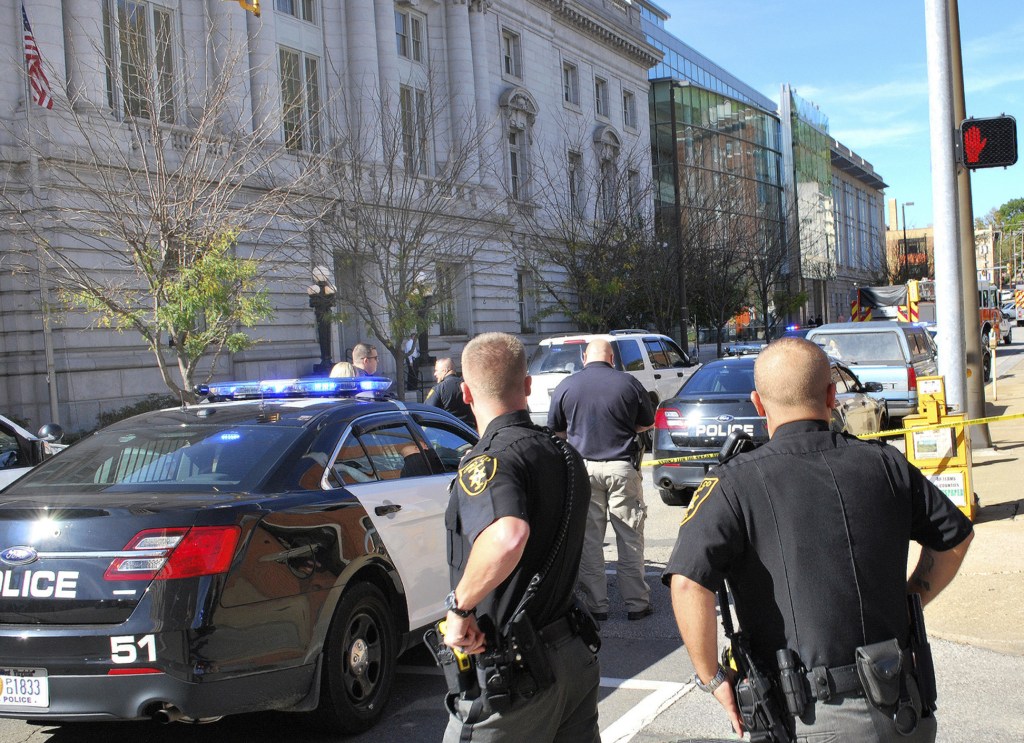 Local law enforcement officers secure an area in front of the Federal Buildng in Wheeling, W.Va., Wedneday following a shooting outside the courthouse.