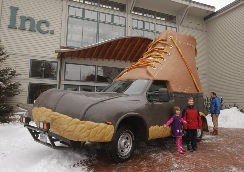 Children pose for a picture next to the L.L. Bean Bootmobile outside the main entrance to the company’s flagship store in Freeport in January 2012. The Bootmobile will visit 15 college campuses this winter.