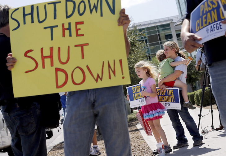 As the federal government shutdown continues, Tory Anderson, right, with her kids Audrey, 7, and Kai, 3, of Goodyear, Ariz., join others as they rally for the Alliance of Retired Americans to end the shutdown in front of the Social Security Administration offices on Wednesday, Oct. 9, 2013, in Phoenix. Other groups rallying to end the government shutdown include Professional Aviation Safety Specialists, the American Federation of Government Employees AFL-CIO, and Arizona FairShare.
