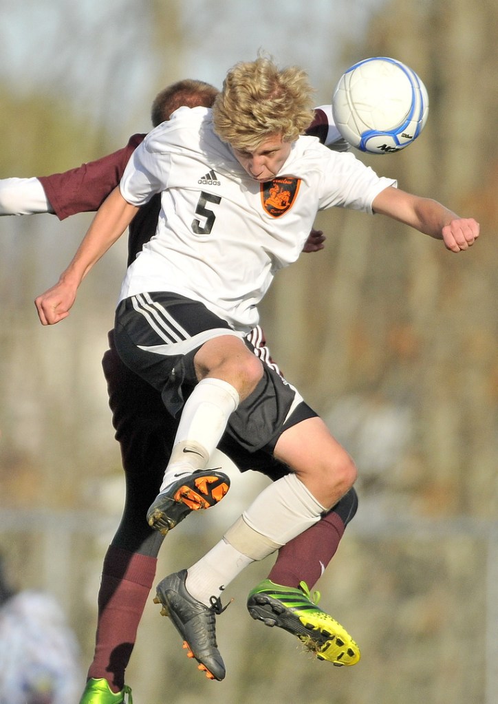 WIN IT: Winslow High School’s Evan Clark (5) battles for the ball with Foxcroft Academy’s Dylan Harmon-Weeks in the second half of the Black Raiders’ 2-1 win over in an Eastern B quarterfinal Wednesday in Winslow.