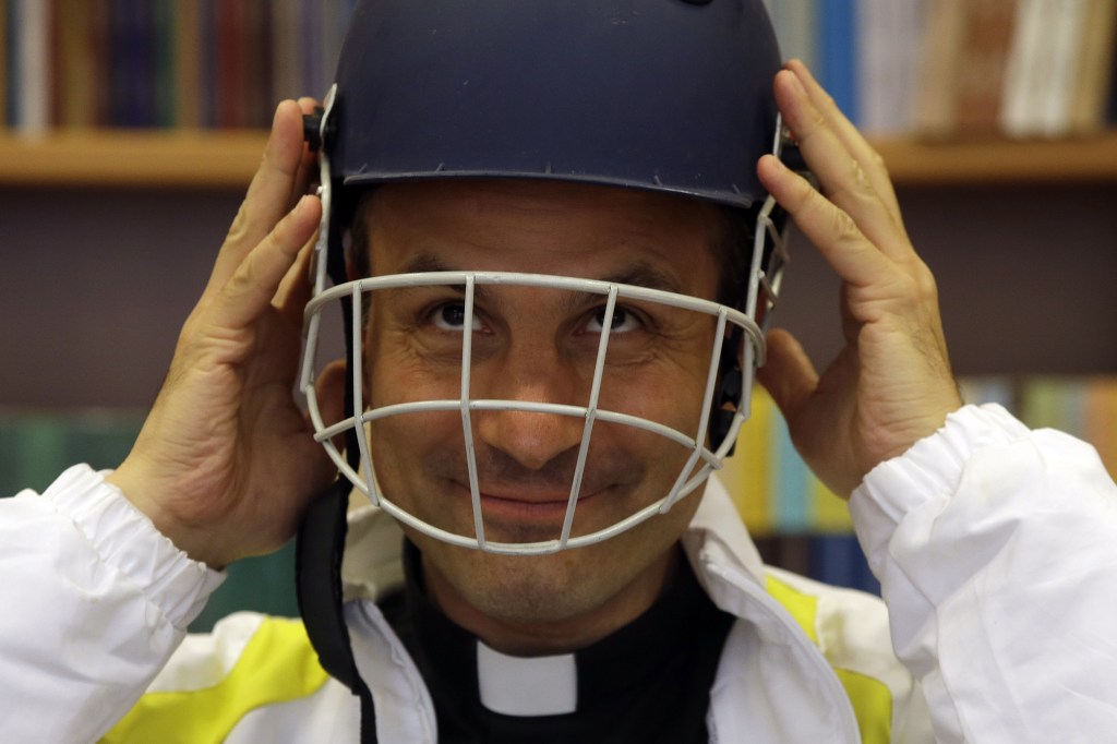 AP Photo/Monsignor Sanchez de Toca y Alameda, undersecretary of the Pontifical Council for Culture, wears a cricket helmet during the presentation of the Vatican cricket club at the Vatican.