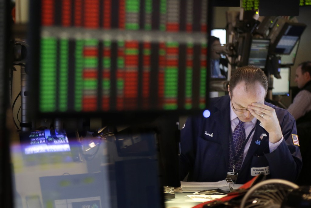 A trader works on the floor at the New York Stock Exchange in New York on Wednesday. Stocks surged after Senate leaders reached a deal that would avoid a U.S. default and reopen the government after 16 days of being partially shut down.