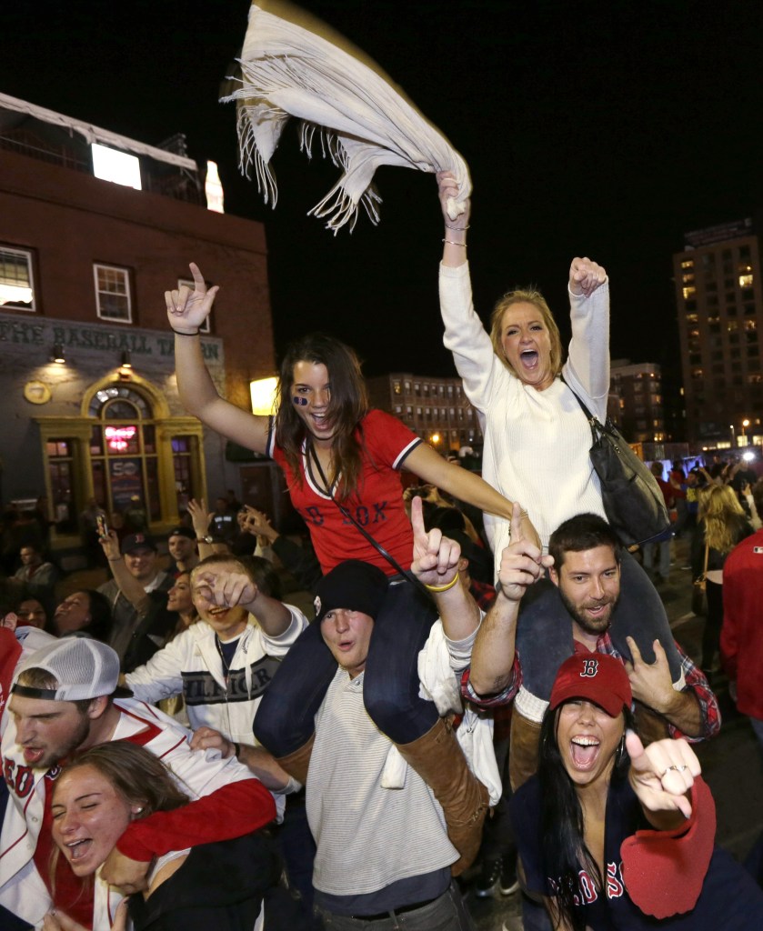 Boston Red Sox fans celebrate in the street near Fenway Park following Game 6 of baseball’s World Series between the Red Sox and the St. Louis Cardinals on Wednesday, Oct. 30, 2013, in Boston. The Red Sox won 6-1 to win the series.
