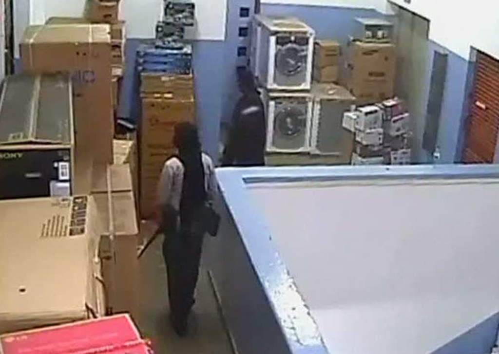 In this video image released by the Kenyan Defence Forces and made available by Citizen TV, men carrying automatic weapons and carrying bags are seen in the storeroom of the Nakumatt shop during the four-day-long siege at the Westgate Mall in Nairobi Kenya which killed more than 60 people last month. A Kenyan military spokesman has confirmed the names of four attackers as Abu Baara al-Sudani, Omar Nabhan, Khattab al-Kene, left, and Umayr.