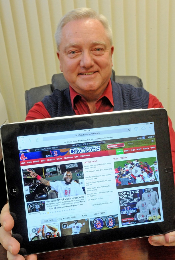 Up late: David Smith, branch manager for Raymond James Financial Services in Waterville, relaxes Thursday after staying up late to watch the Red Sox win the World Series.