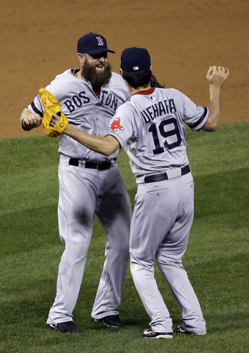 Boston Red Sox relief pitcher Koji Uehara celebrates with teammate Mike Napoli after getting St. Louis Cardinals’ Matt Holliday to fly out and end Game 5 of baseball’s World Series Monday, Oct. 28, 2013, in St. Louis. The Red Sox won 3-1 to take a 3-2 lead in the series.