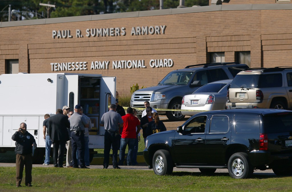 Law enforcement and military personnel investigate the scene where shootings occurred at an armory outside a U.S. Navy Base in Millington, Tenn., on Thursday.
