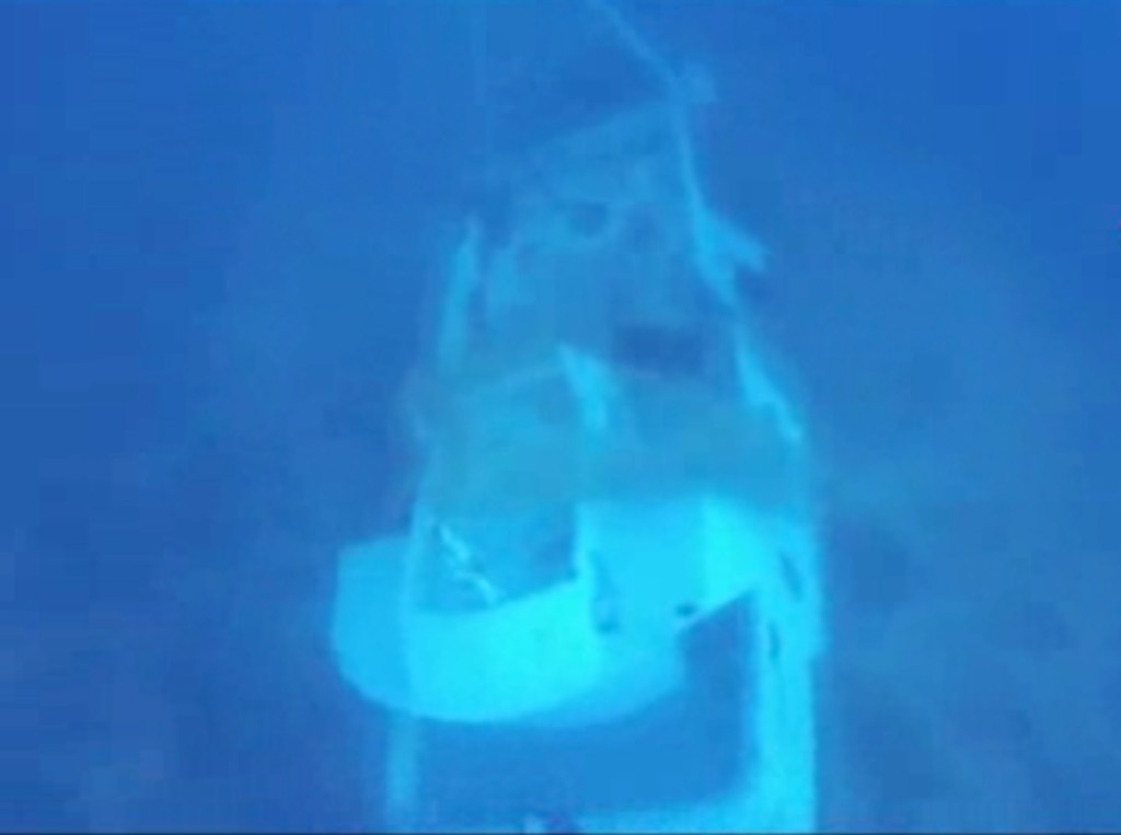 In this image made from video provided by Italian Firefighters, a boat lies underwater Friday. It was transporting hundreds of migrants before catching fire and sinking off the Sicilian island of Lampedusa, Italy, on Thursday.