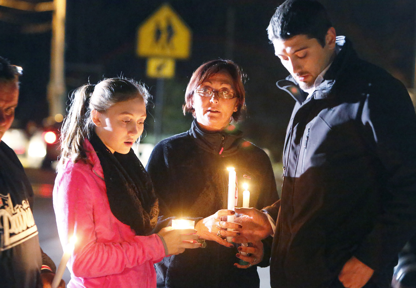 Parents and Danvers High School students hold candlelight vigil to mourn the death of Colleen Ritzer, a 24-year-old math teacher at Danvers High School, on Wednesday, Oct 23, 2013, in Danvers, Mass. Ritzer’s body was found in woods behind the school, and Danvers High School student Philip Chism, 14, who was found walking along a state highway overnight, was charged with killing her.