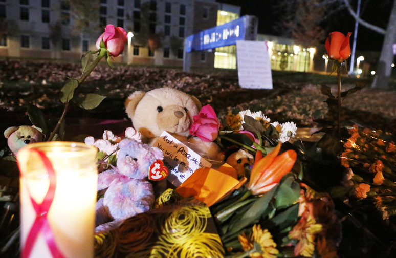 Candles and teddy bears are placed at Danvers High School prior to a candlelight vigil to mourn the death of Colleen Ritzer, a 24-year-old math teacher at Danvers High School on Wednesday, Oct 23, 2013, in Danvers, Mass. Ritzer was found slain in woods behind the high school, and Danvers High School student Philip Chism, 14, who was found walking along a state highway overnight was charged with killing her.
