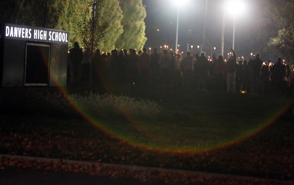 Danvers High School students hold a candlelight vigil to mourn the death of Colleen Ritzer, a 24-year-old math teacher at the school, on Wednesday, Oct 23, 2013, in Danvers, Mass. Ritzer’s body was found in woods behind the school, and Danvers High School student Philip Chism, 14, who was found walking along a state highway overnight, was charged with killing her.