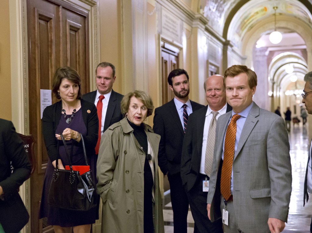 House members and congressional staff, including Rep. Cathy McMorris Rodgers, R-Wash., left, head of the Republican Conference, left, moving past Rep. Louise Slaughter, D-N.Y., third from left, the top Democrat on the House Rules Committee, leave the Capitol at the end of the night after a planned vote in the House of Representatives collapsed, Tuesday, Oct. 15, 2013, at the Capitol in Washington. Time growing desperately short, House Republicans pushed for passage of legislation late Tuesday to prevent a threatened Treasury default, end a 15-day partial government shutdown and extricate divided government from its latest brush with a full political meltdown.