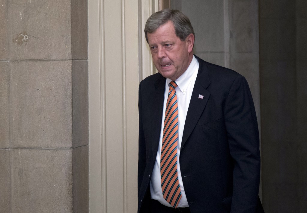 Rep. Tom Lathem, R-Iowa, walks past reporters on Capitol Hill, Tuesday, Oct. 15, 2013, in Washington. The partial government shutdown is in its third week and less than two days before the Treasury Department says it will be unable to borrow and will rely on a cash cushion to pay the country’s bills.