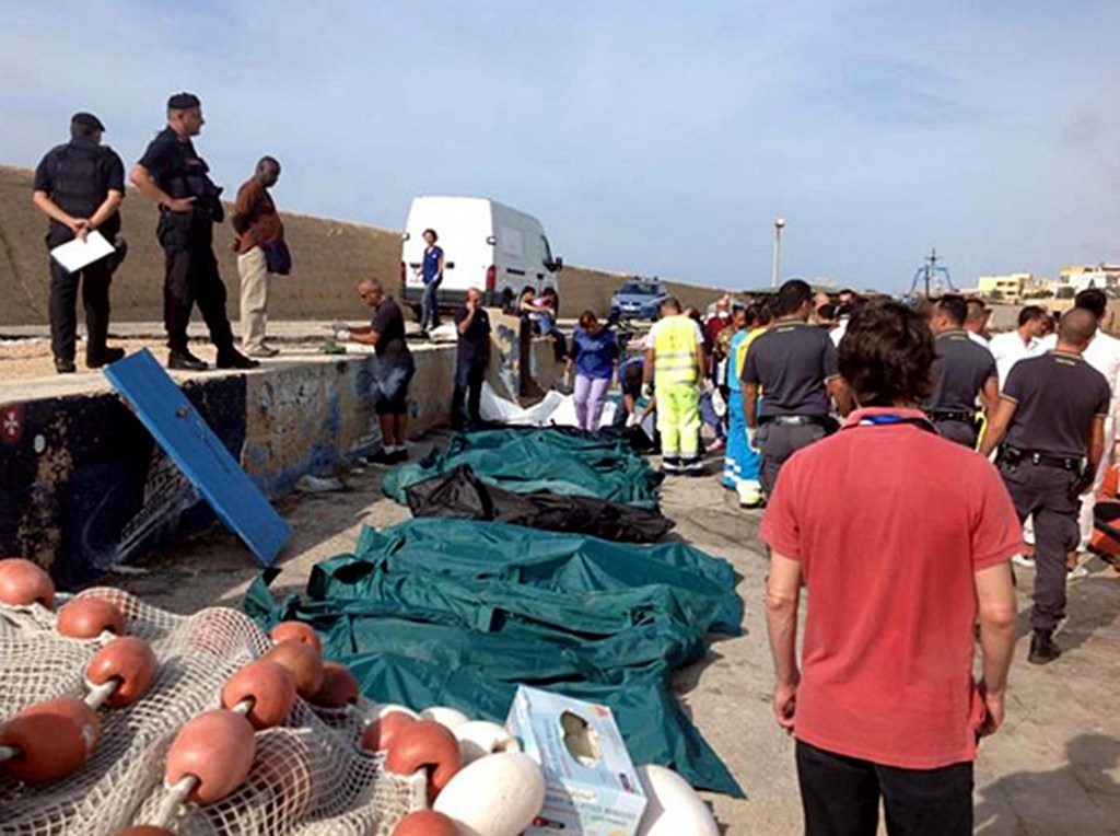 Bodies of drowned migrants are lined up in the port of Lampedusa Thursday, Oct. 3, 2013. A ship carrying African migrants to Europe caught fire and capsized off the Italian island of Lampedusa on Thursday, killing at least 94 people as it spilled hundreds of passengers into the sea, officials said. Over 150 people were rescued but some 200 others were still unaccounted for. It was one of the deadliest recent accidents in the notoriously perilous Mediterranean Sea crossing from Africa for migrants seeking a new life in the European Union.