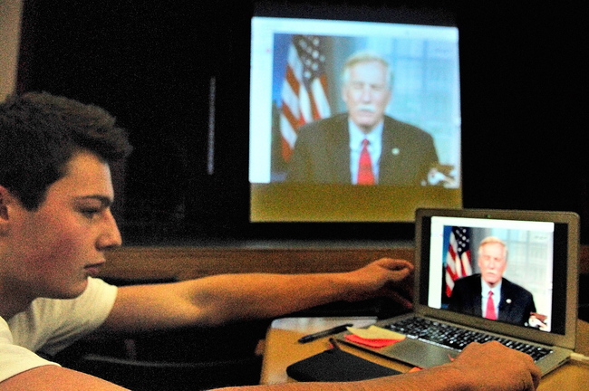 Matthew Mills turns the laptop back to face the rest of the audience after asking Sen. Angus King, I-Maine, a question about national debt during a Skype session today at Hall-Dale High School in Farmingdale.