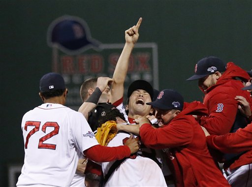 Boston Red Sox relief pitcher Koji Uehara, center, celebrates with teammates after the Red Sox 5-2 beat the Detroit Tigers in Game 6 of the American League baseball championship series on Saturday, Oct. 19, 2013, in Boston. The Red Sox advance to the World Series. (AP Photo/Tim Donnelly)