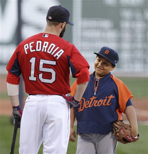 Victor Jose Martinez, son of Tigers’ designated hitter Victor Martinez, talks with Red Sox second baseman Dustin Pedroia on Friday at Fenway Park in Boston. Fenway Park