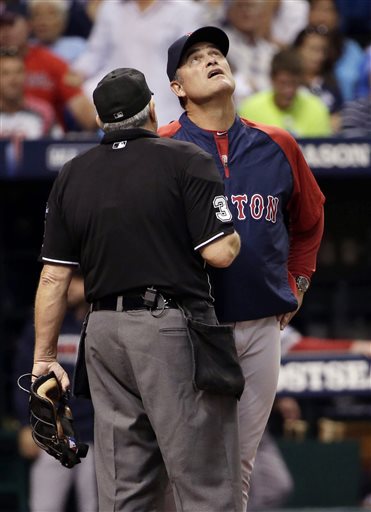 Boston Red Sox manager John Farrell, right, questions home plate umpire Paul Emmel after a fourth inning foul ball by Tampa Bay Rays' Ben Zobrist hits the catwalk in Game 3 of an American League baseball division series, Monday, Oct. 7, 2013, in St. Petersburg, Fla. (AP Photo/Chris O'Meara) Tropicana Field