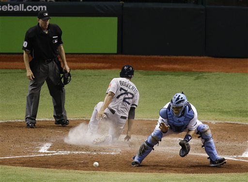 Tampa Bay Rays catcher Jose Molina, right, waits for a throw as Boston Red Sox's Xander Bogaerts (72) slides home to score a run in the ninth inning of Game 4 of baseball's American League division series, Tuesday in St. Petersburg, Fla. Boston won the game 3-1. Tropicana Field;Tampa Bay Rays