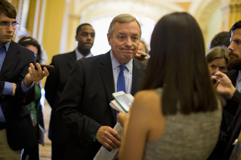 Senate Majority Whip Richard Durbin of Illinois talks with reporters on Capitol Hill in Washington on Monday before a Senate Democratic caucus to discuss the budget fight.