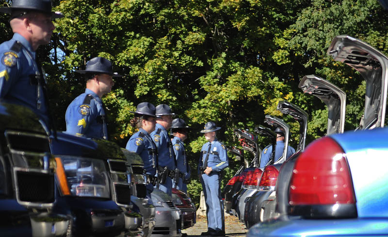 State Police Col. Robert Williams, center, inspects officers and their vehicles Tuesday at the capitol in Augusta. Each trooper and vehicle was reviewed individually by the agency's majors and colonels during the ceremony.