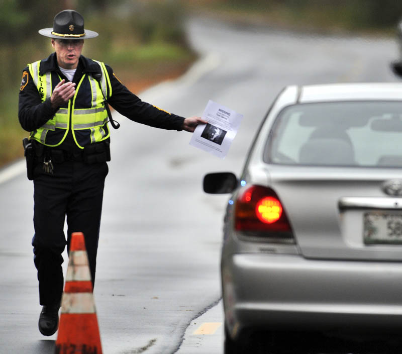 STILL MISSING: Winthrop Police Dept. Captain Ryan Frost pulls over a motorist Sunday October 13, 2013 on the Stanley Road in Winthrop while conducting a road block to ask motorists about Thomas Devoy, who has been missing from his Winthrop home since last Sunday. Police still have no clues about the 60-year-old's whereabouts and were hoping to receive information that provide a lead during the roadblock, according to Frost. Police provided drivers a flyer with a photo and description of Devoy with a request for anyone with information to call the Winthrop Police.