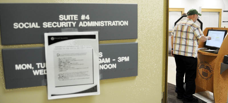 Don Register fills out a form today at the Social Security Administration's offices in Augusta. The federal agency has reduced services because of the shutdown by is still providing assistance to some. "I think it's crazy," the Augusta resident said of the closure of federal government offices.