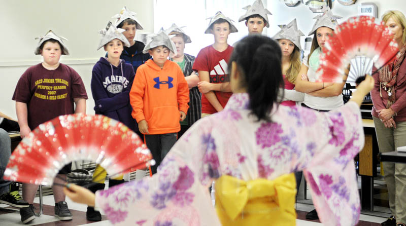 Richmond Middle School students watch exchange student Satoko Suwanai, 16, perform a traditional Japanese dance Tuesday at the school in Richmond. The school hosted 10 teenagers and four chaperones participating in the annual exchange with Hall-Dale High School. Richmond students learned about Japanese origami, music and tea ceremonies in addition to dance. Richmond schools began teaching Japanese last year, according to principal Steve Lavoie.