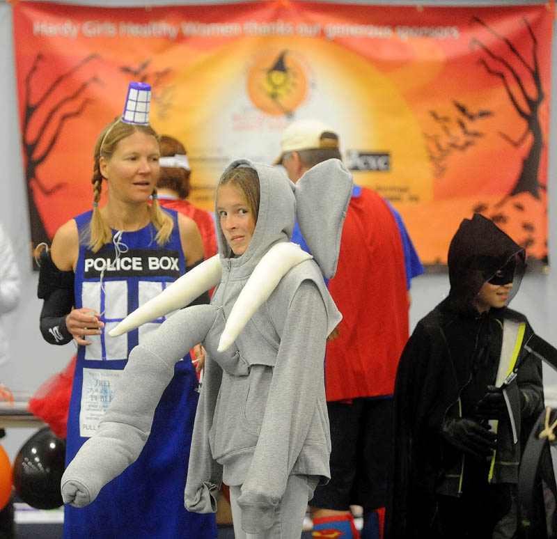 Alison Stabins, 11, center, dressed as an elephant as her mother Amy, left, dressed as Tardis from "Dr. Who," wait for the start of the Freaky 5K Fun Run organized by Hardy Girls Healthy Women at the Colby College field house today.