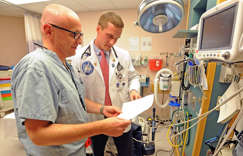 Brandon Giberson, 26, right, works with Dr. John Comis, director of the emergency department at Redington-Fairview General Hospital in Skowhegan, on Wednesday. Comis has acted as a mentor to Giberson since Giberson was a high school volunteer.