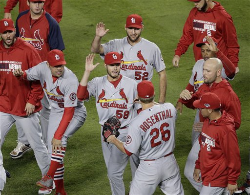 St. Louis Cardinals relief pitcher Trevor Rosenthal (26) is congratulated by teammates after Game 4 of the National League baseball championship series against the Los Angeles Dodgers Tuesday, Oct. 15, 2013, in Los Angeles. The Cardinals won 4-2 to take a 3-1 lead in the series. (AP Photo/Jae C. Hong)