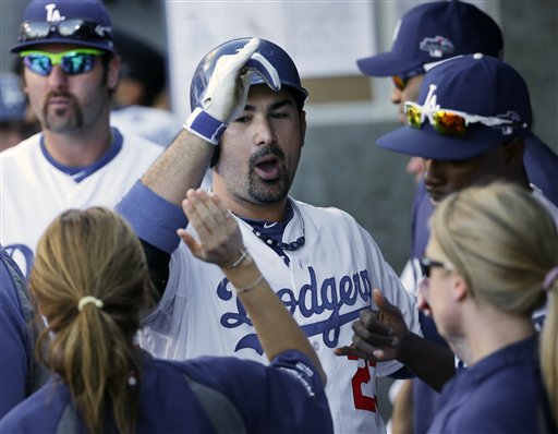 ALL RIGHT: Los Angeles’ Adrian Gonzalez celebrates in the dugout after hitting a home run during the eighth inning of Game 5 of the National League Championship Series on Wednesday against the St. Louis Cardinals in Los Angeles. The Dodgers won 6-4 to avoid elimination.