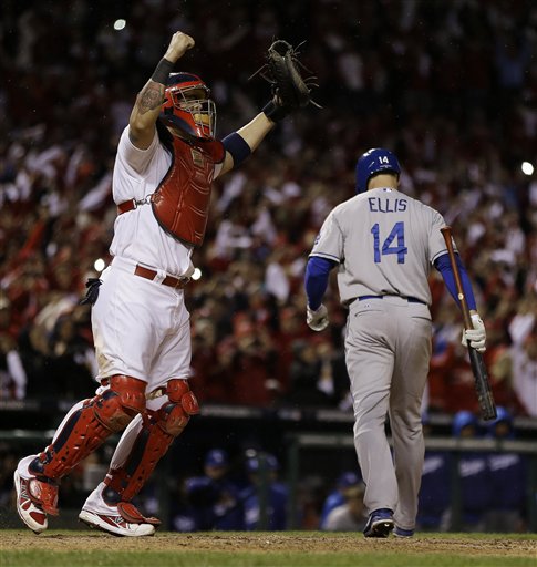 St. Louis Cardinals catcher Yadier Molina reacts after Los Angeles Dodgers' Mark Ellis strikes out to end Game 6 of the National League baseball championship series Friday, Oct. 18, 2013, in St. Louis. The Cardinals won 9-0 to win the series. (AP Photo/Jeff Roberson)