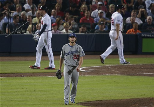 Los Angeles Dodgers starting pitcher Clayton Kershaw (22) walks to the mound after striking out Atlanta Braves first baseman Freddie Freeman (5) in the sixth inning of Game 1 of the National League Divisional Series, Thursday, Oct. 3, 2013, in Atlanta. (AP Photo/Dave Martin) Turner Field